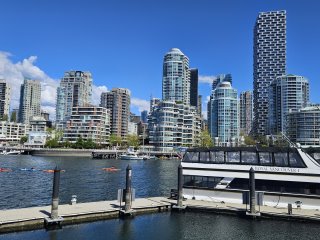 A city skyline with boats on the water

Description automatically generated