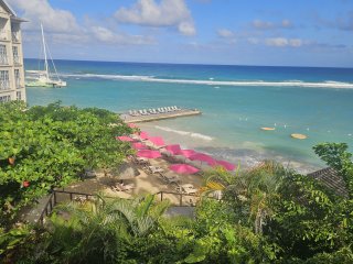 A beach with umbrellas and boats

AI-generated content may be incorrect.