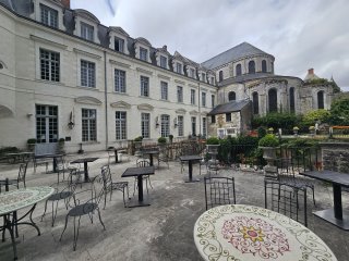 A courtyard with tables and chairs

Description automatically generated with low confidence