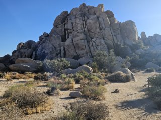 A large rock formation in the desert

Description automatically generated