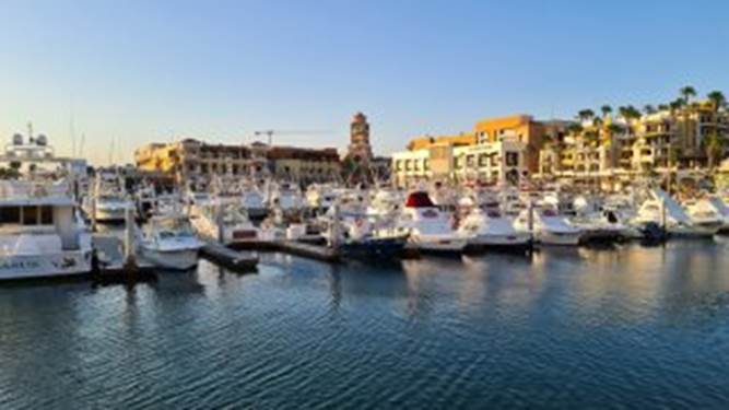 A body of water with boats in it and buildings in the background

Description automatically generated with medium confidence