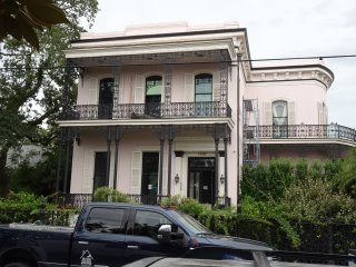 A white house with cars parked in front of it

Description automatically generated with medium confidence