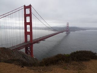 A large red bridge over a body of water

Description automatically generated with medium confidence